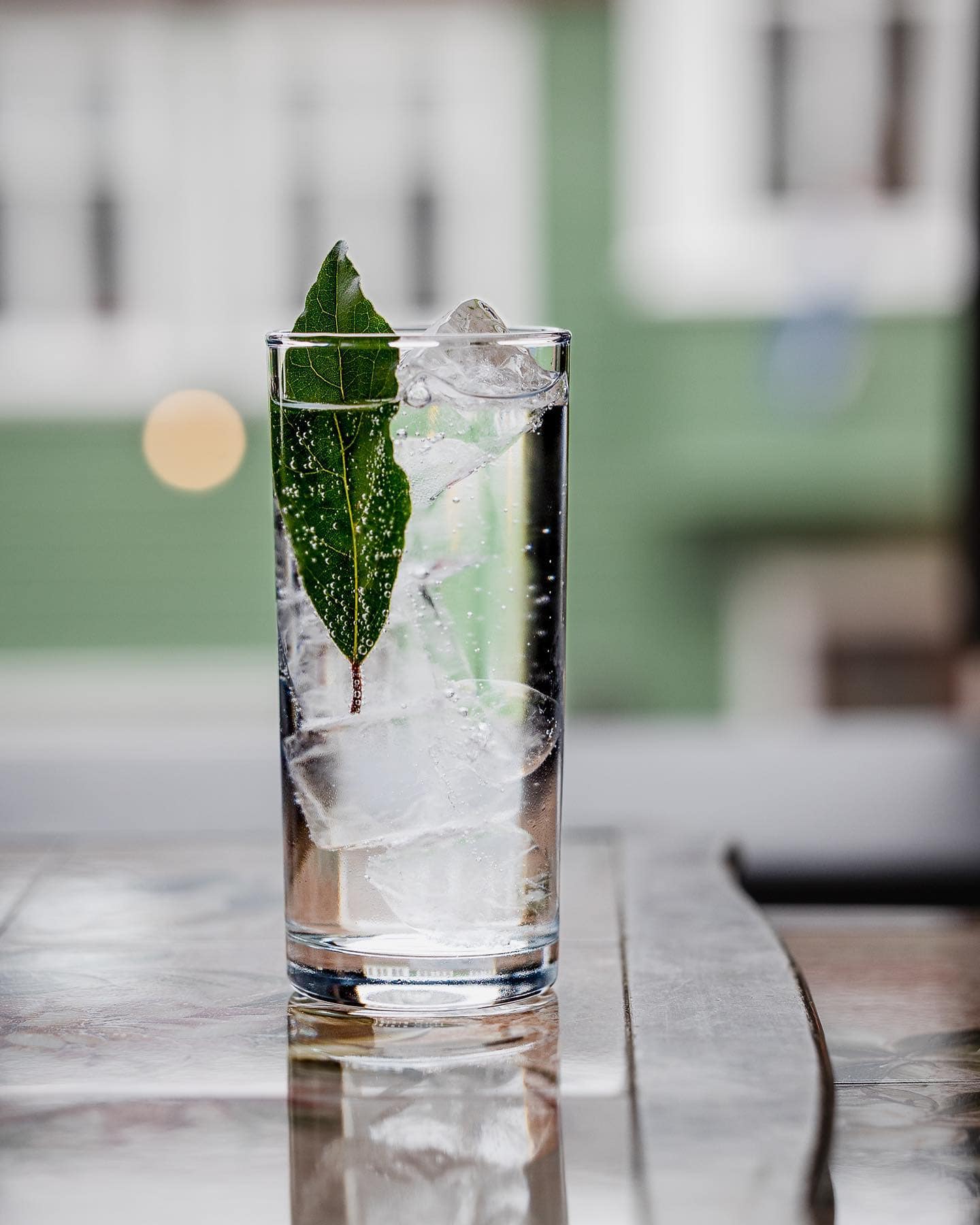 An olive cocktail on a wooden table