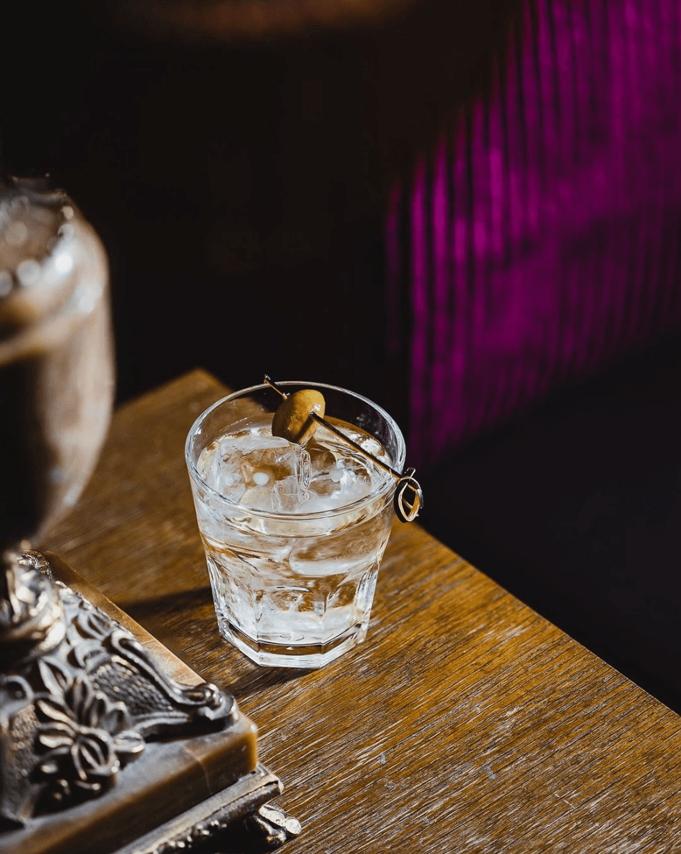 An orange cocktail in a frosted mug
